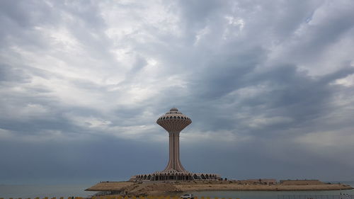 Low angle view of tower against cloudy sky