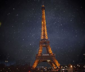 Low angle view of illuminated tower against sky at night