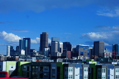 Buildings in city against blue sky