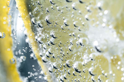 Close-up of bubbles with lemon slice