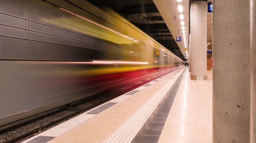 Blurred motion of train at railroad station