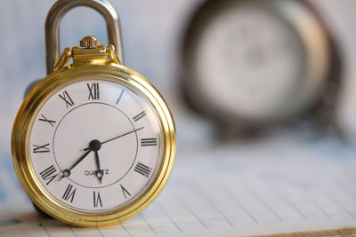 Close-up of pocket watch on table