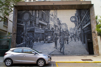 Cars on street by buildings in city