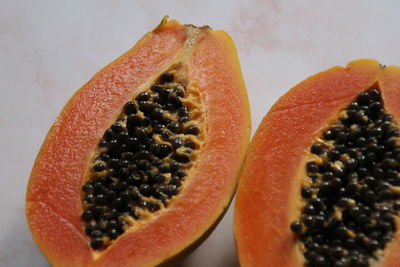 Close-up of orange fruit against white background