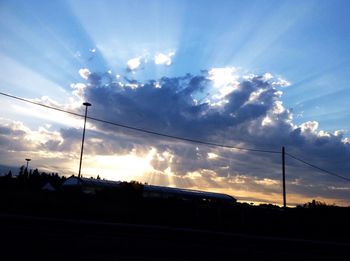 Low angle view of electricity pylon against sky