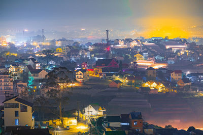 High angle view of illuminated cityscape against sky during sunset