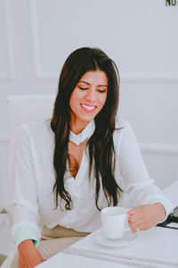 Portrait of a young woman with coffee cup