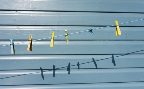 Close-up of clothespins hanging on clothesline