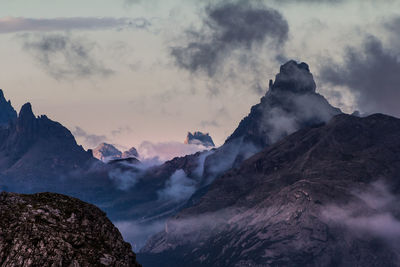 Scenic view of mountains against cloudy sky