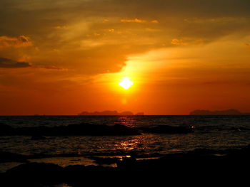 Scenic view of sea against romantic sky at sunset