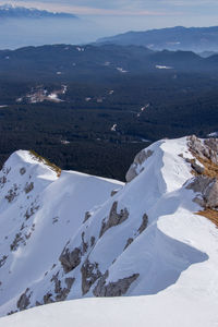 High angle view of snowcapped mountains against sky