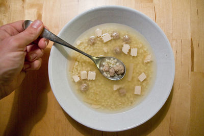 High angle view of man having breakfast on table