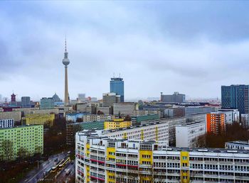 View of cityscape against cloudy sky