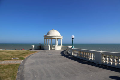 Lifeguard hut on beach against clear blue sky