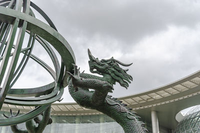 Low angle view of statue against cloudy sky