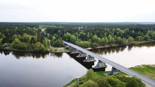 Scenic view of river by trees against sky