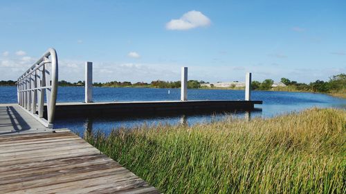 Pier over lake against sky