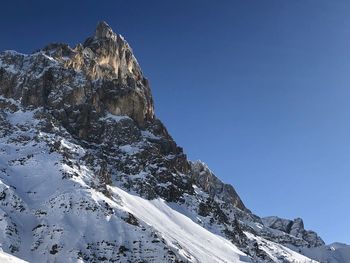 Scenic view of snowcapped mountains against clear sky