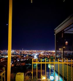 High angle view of illuminated buildings against sky at night