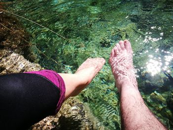 Low section of woman legs in water