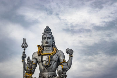 Low angle view of statue against sky