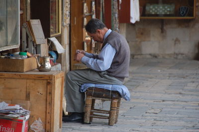 Side view of man using mobile phone