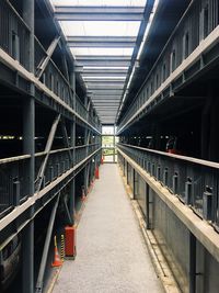 Empty elevated walkway amidst buildings