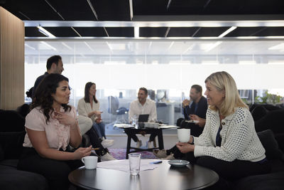 Group of business people having meeting in lobby