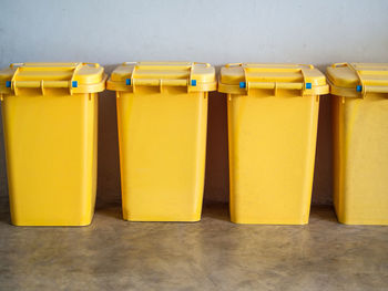 Close-up of yellow arranged on table against wall