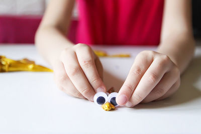 Midsection of woman holding toy against white background