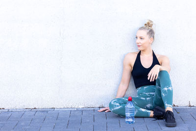 Portrait of young woman sitting on floor