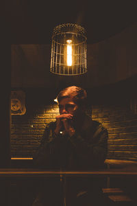 Man photographing illuminated light