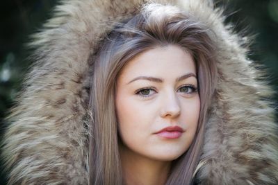 Close-up portrait of a woman in snow