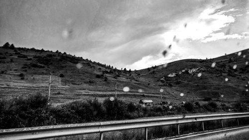 Road by mountain against sky