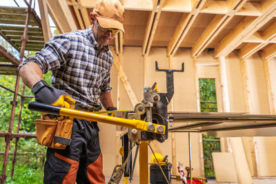 Side view of man working in workshop