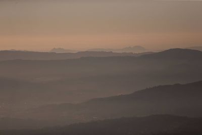 Scenic view of silhouette mountains against sky during sunset