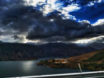 Scenic view of mountains against cloudy sky