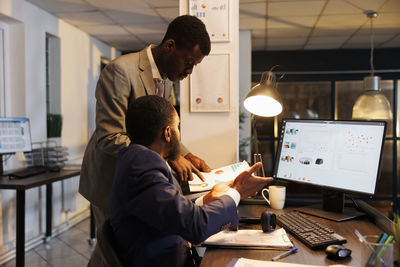 Side view of colleagues working at office