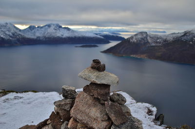 Scenic view of rocks by lake against sky