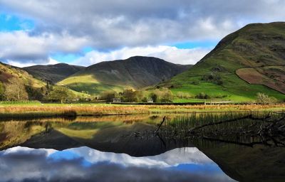 Scenic view of lake and mountains against sky