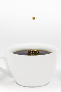 Close-up of coffee cup over white background
