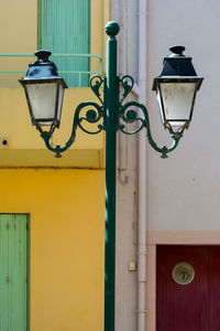 Close-up of lamp against blue wall