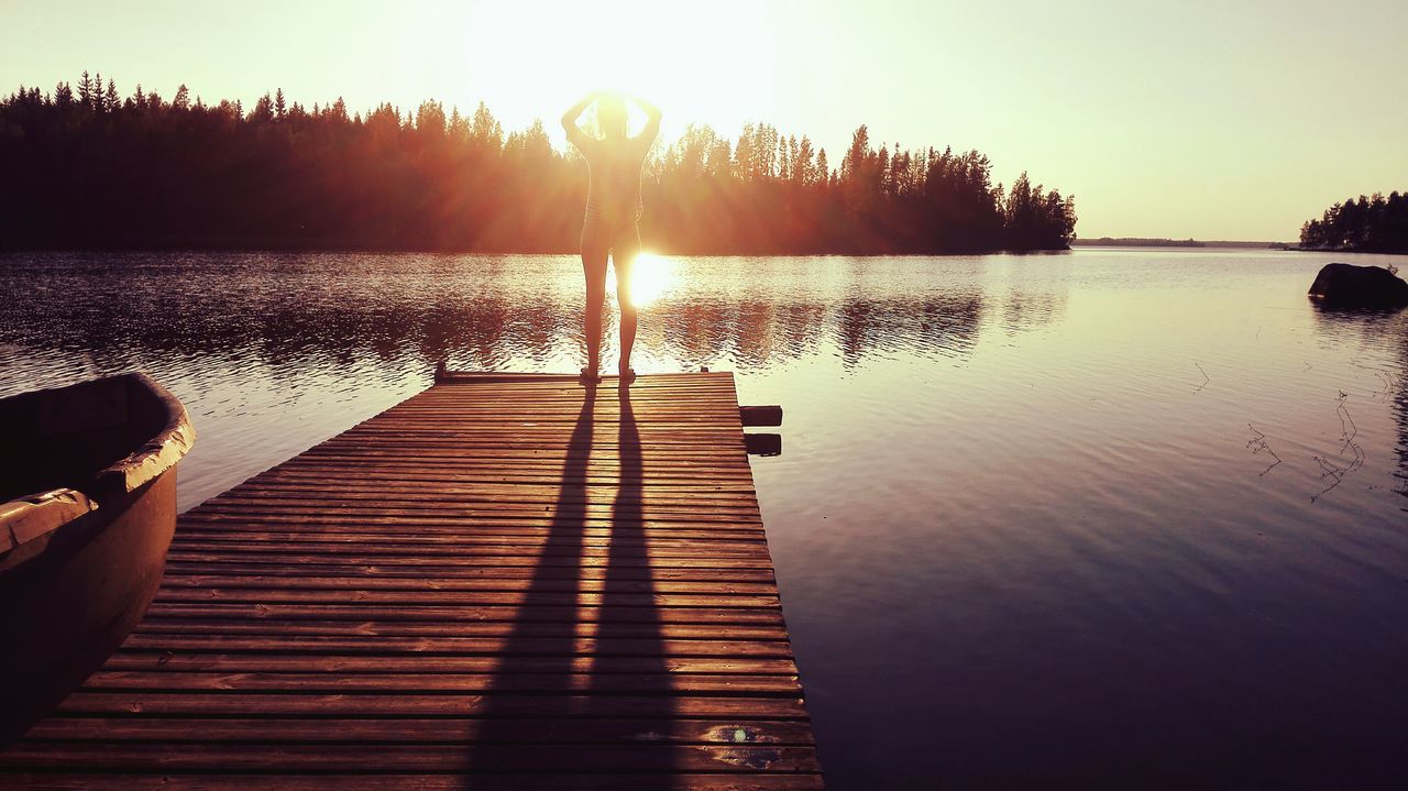 water, sun, sunset, reflection, lake, tranquil scene, sunlight, tranquility, silhouette, scenics, sunbeam, beauty in nature, pier, clear sky, nature, jetty, rippled, sky, lens flare, idyllic