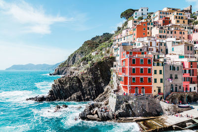 Panoramic view of sea and buildings against sky