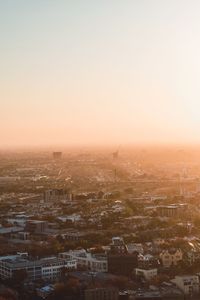 High angle view of buildings against clear sky at sunset