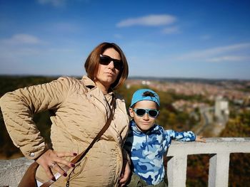 Portrait of mother and son standing at observation point