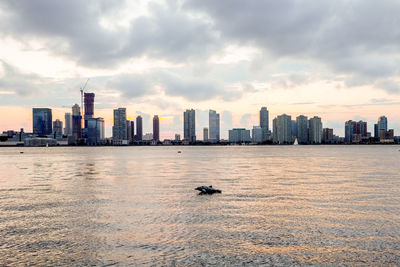 Skyscrapers against cloudy sky