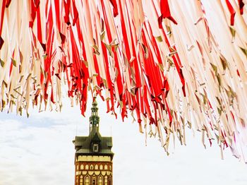 Low angle view of red bell tower against sky