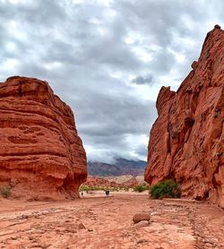 Rock formations on red mountain against sky