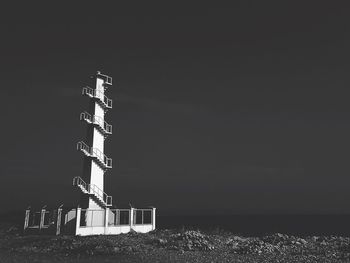 Low angle view of lighthouse at beach against clear